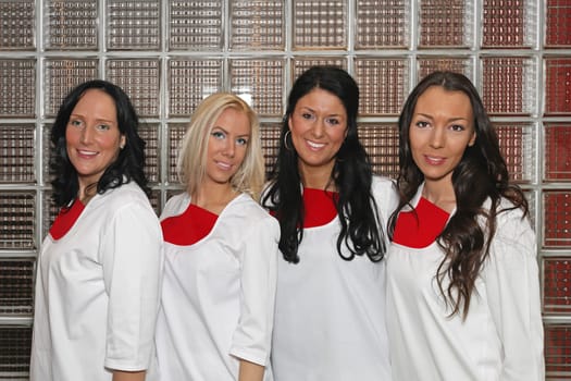 Four female doctors wearing white uniforms