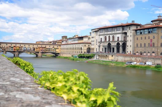 Picturesque view on colorful Ponte Vecchio over Arno River in Florence, Italy