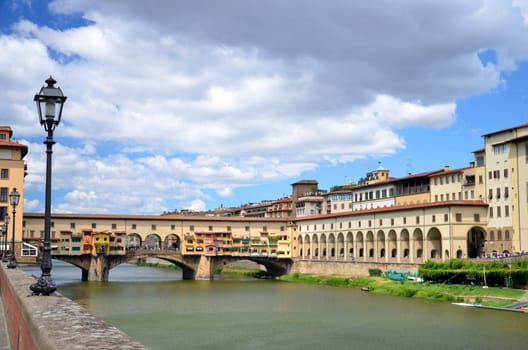 Picturesque view on colorful Ponte Vecchio over Arno River in Florence, Italy