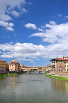 Picturesque view on colorful Ponte Vecchio over Arno River in Florence, Italy
