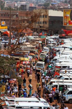 KAMPALA, UGANDA - SEPTEMBER 28, 2012. People walk through the taxi park going amongst their business in Kampala, Uganda on September 28,2012.