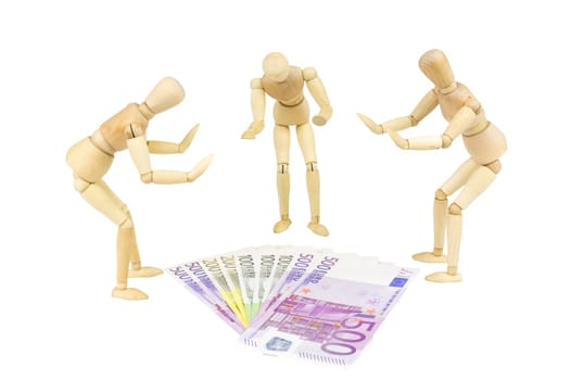 Wooden figures symbolize the worship of money