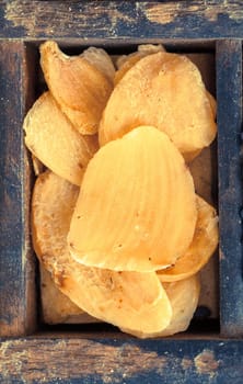 Dried flakes of grated garlic for use as a seasoning and flavouring in cooking, close up view showing the texture