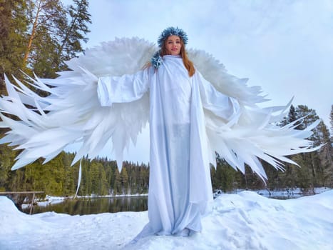 Girls in elegant white dresses pose by the lake, capturing the enchanting essence of winter and the beauty of nature's seasons.