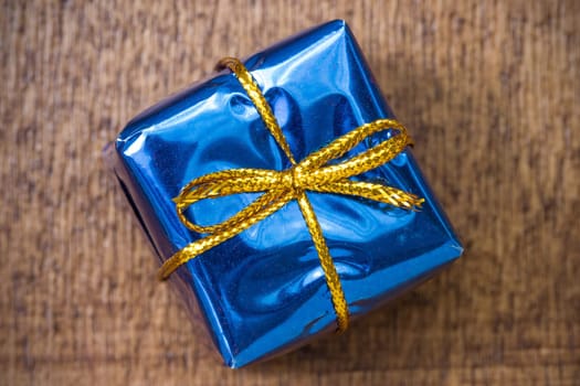 Blue gift box on the wooden background
