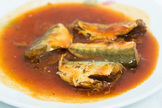 Canned fish in tomato sauce on dish