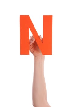 A Hand Holds a Orange N, Isolated