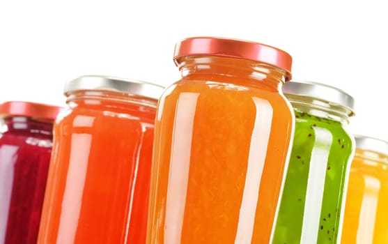 Jars of fruity jams isolated on white background. Preserved fruits