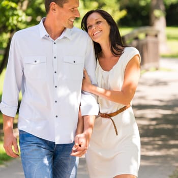 Portrait of young happy couple embracing in park