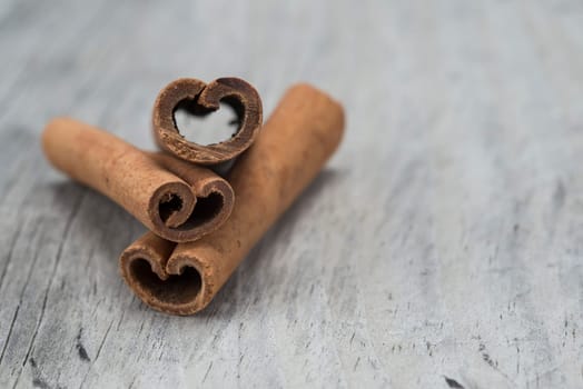 Cinnamon sticks on an old wooden table background