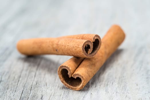 Cinnamon sticks on an old wooden table background