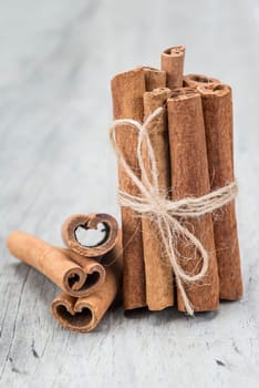 Cinnamon sticks on an old wooden table background