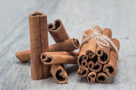 Cinnamon sticks on an old wooden table background
