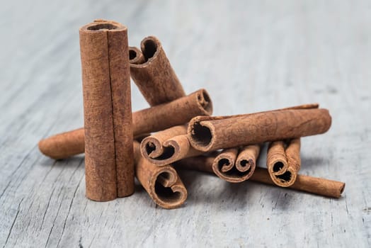 Cinnamon sticks on an old wooden table background