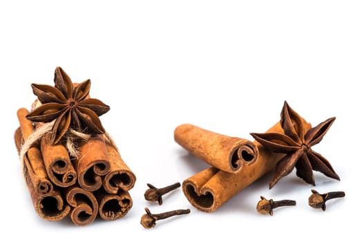 Cinnamon sticks and star anise isolated over a white background