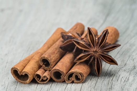 Cinnamon sticks and star anise on a wooden background