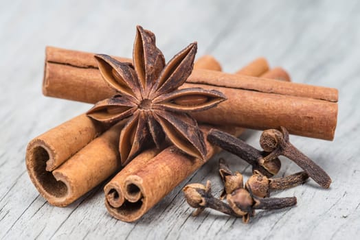Cinnamon sticks and star anise on a wooden background