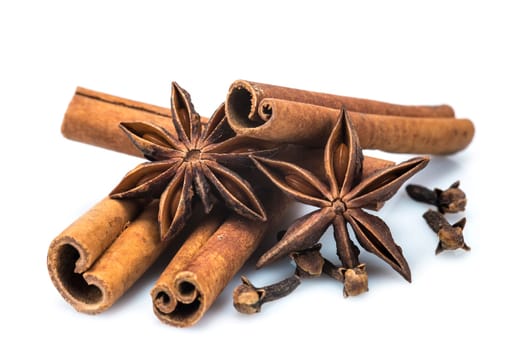 Cinnamon sticks and star anise isolated over a white background