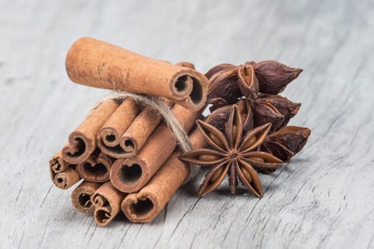 Cinnamon sticks and star anise on a wooden background