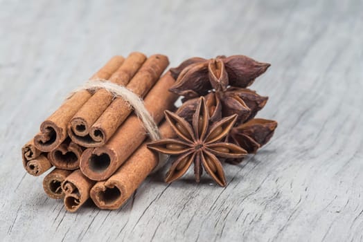 Cinnamon sticks and star anise on a wooden background