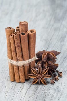 Cinnamon sticks and star anise on a wooden background