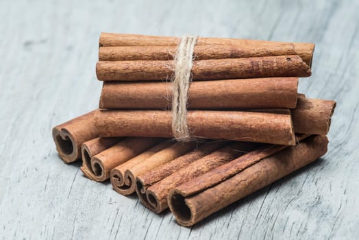 Cinnamon sticks on an old wooden table background