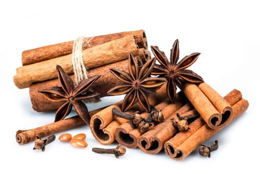 Cinnamon sticks and star anise isolated over a white background