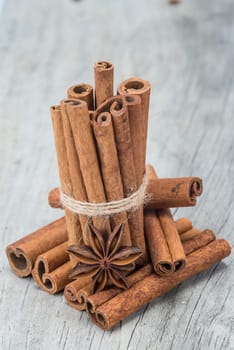 Cinnamon sticks and star anise on a wooden background