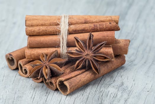 Cinnamon sticks and star anise on a wooden background