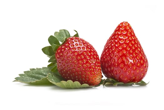 Strawberries with their leaves isolated on a white background