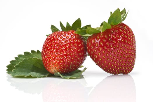 Strawberries with their leaves isolated on a white background