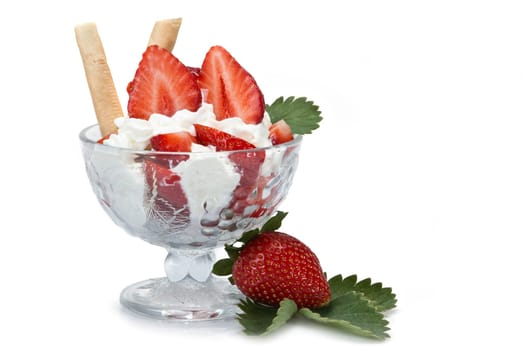 Strawberries and whipped cream cup isolated over a white background.