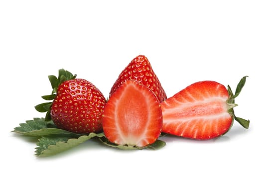 Strawberries with their leaves isolated on a white background