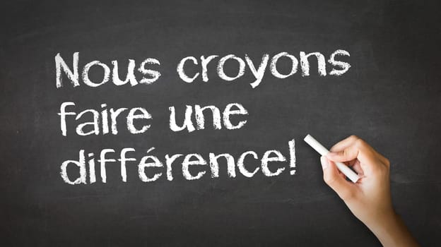 A person drawing and pointing at a We believe in making a difference Chalk Illustration