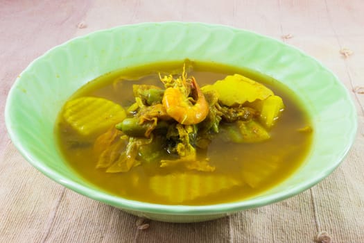 Shrimp And Mixed Vegetable In Tamarind Sauce or Shrimp Sour Curry ( Kang som Gung ) . Thai recipe name pronunciation Shrimp Sour Curry is a traditional food of  Thailand.Shrimp Sour Curry is a traditional food of Central & Southern Thailand. Think of it as curried soup. Although the ingredients are the same for the two refions, the south of Thailand variation tastes more spicy because they add more dry chilli during cooking. The Central Thailand version is closer to sweet and sour soup and is the one given here. This is medium hot.