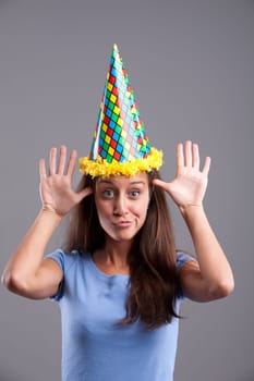 Party clown hat girl showing funny faces