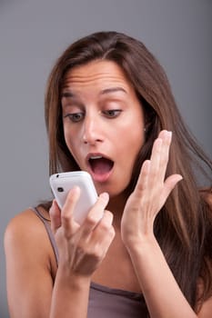 Young girl receiving shocking and unexpected news over the phone