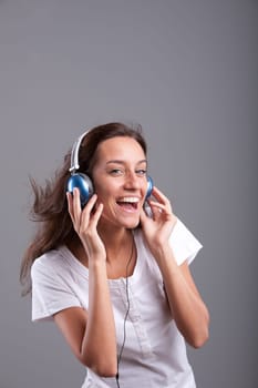 Beautiful girl laughingh and enjoying music she listens to