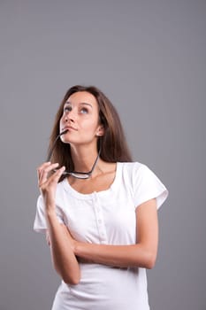 Pretty woman thinking or dreaming about infinite possibilities