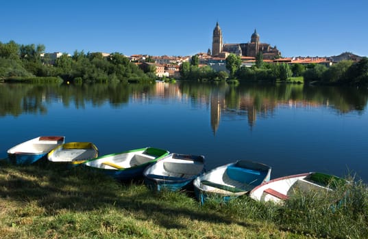 Dock of rawboats at Tormes river, in front of Salamanca of the Cathedral of Salamanca