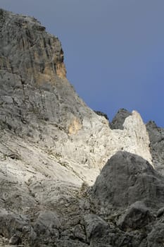 Sunlight on big rock in Alps mountains, France