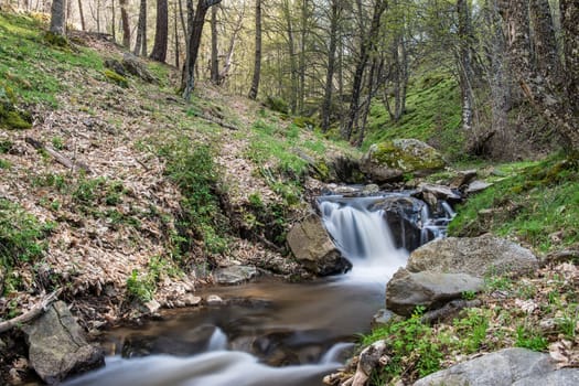 Cascades on a mountain river with a silky effect on the water that conveys a sense of relaxation.