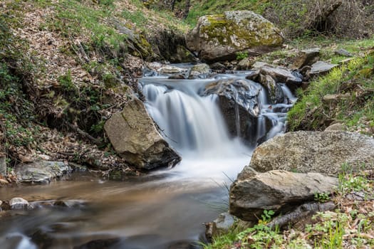 Cascades on a mountain river with a silky effect on the water that conveys a sense of relaxation.