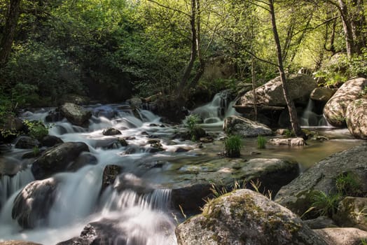 Cascades on a mountain river with a silky effect on the water that conveys a sense of relaxation.