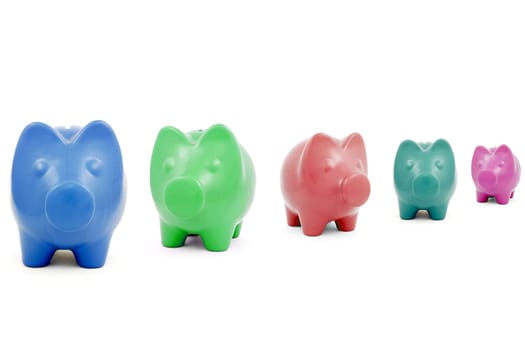 Colourful Piggy banks in a row over a white background