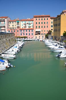 Picturesque view on boats in city channel in Livorno, Italy