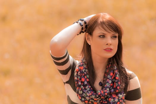 Portrait of a nice looking and thoughtful woman. Outdoor in summer or fall. With copy space.