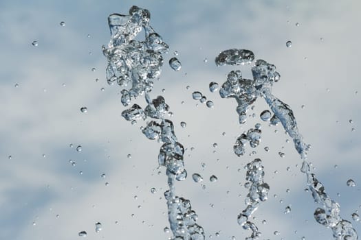 Spectacular freeze of fluid while splashing to the sky. With blue background.