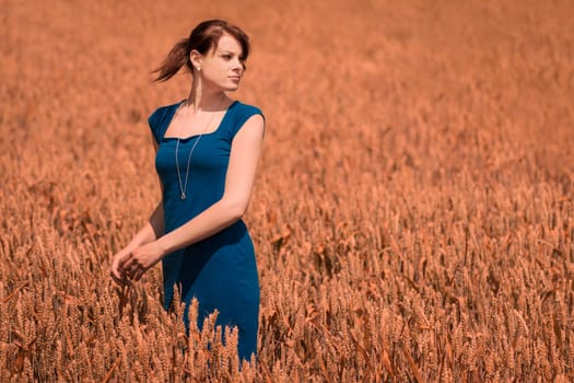 The blue of the dress is the only blue in the picture - perfect for coloration. The model looks to the copy space on the right side.