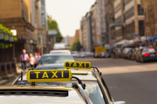 Two taxis waiting for a businessman at the street in city. Nice depth of field. With copy space..